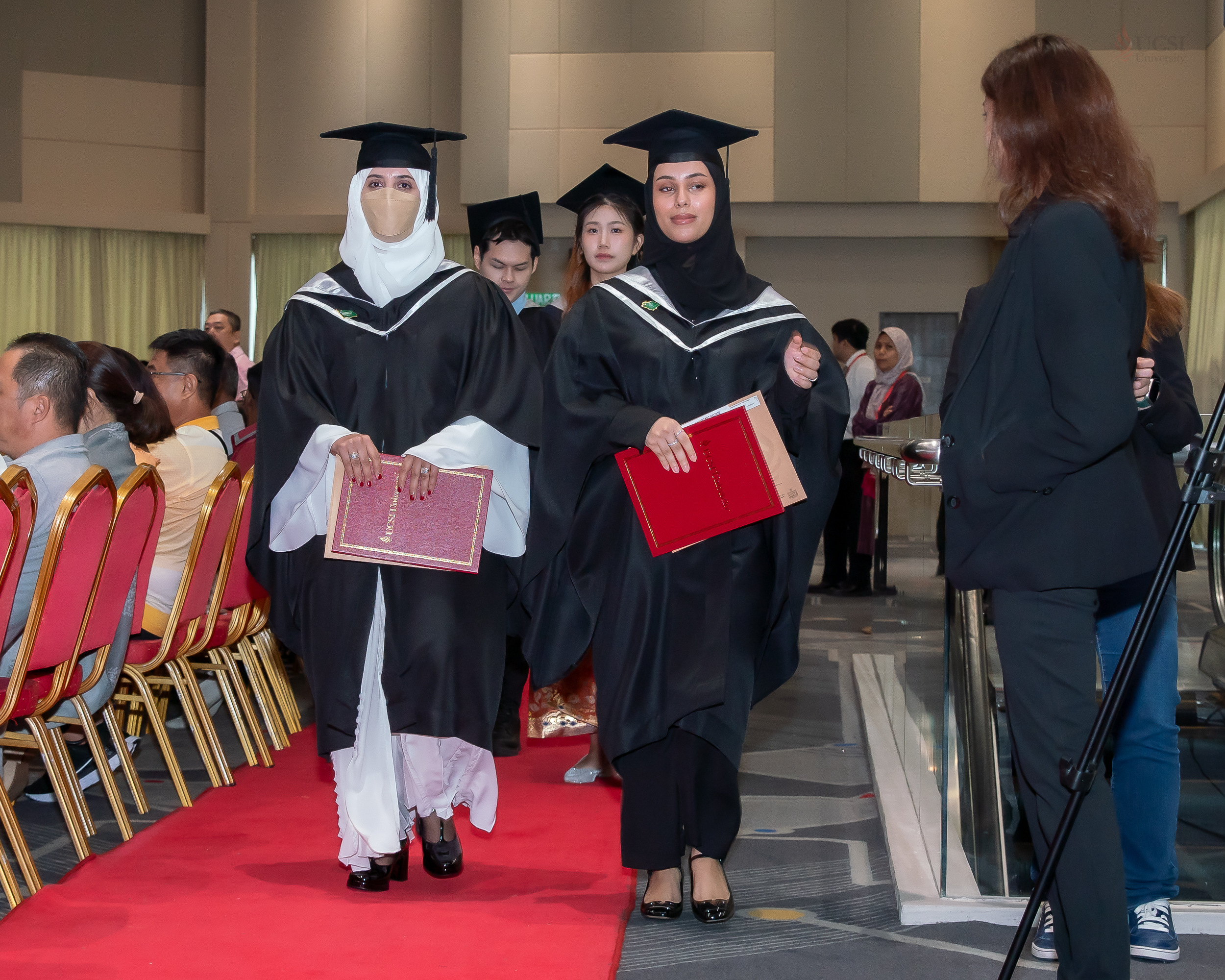 From left: Mother and daughter, Moneerah Homoud B. Alblaihed and Jawaher Fahad M. Alshemmeri, walk side by side in their graduation gowns, both beaming with pride after receiving their Master's degrees in International Hospitality Management from UCSI University. 