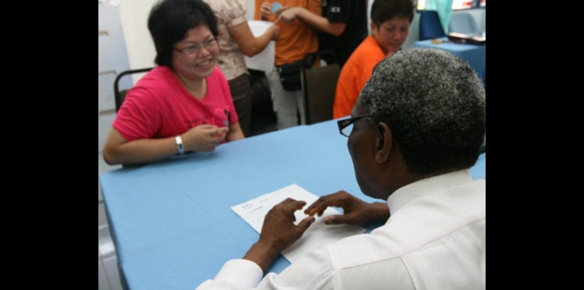  Dr. Ogunbanjo counsels one of the residents who participated in the health screening tests at the community centre.