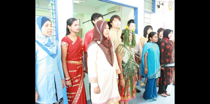  1Malaysia: Nursing students singing the national anthem dressed in attires representing the multi-ethnicity of Malaysia