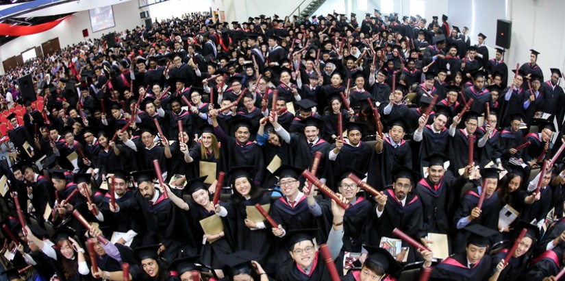 A clearly overjoyed Class of 2017 proudly showing their hard-earned scroll