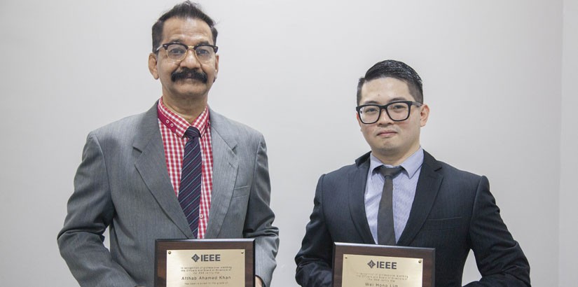 Dr Ahamed Khan and Dr Lim with their respective awards from IEEE.