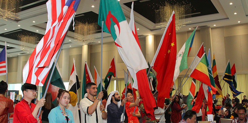 UCSI Students from different countries waving their flags.