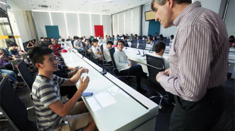 Dr Joseph Manning (right) answers a student’s question on non-computable functions.