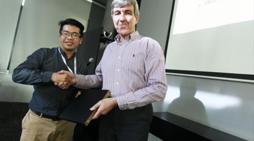 Assistant Professor Dr Tan Chun Wei (left), Head of UCSI’s School of IT, presents Dr Manning with a token of appreciation.