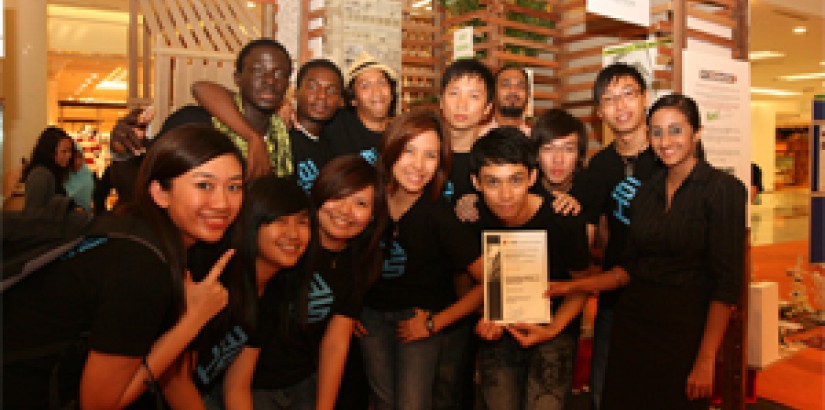 Jubilant UCSI University students in front of their award-winning exhibition booth