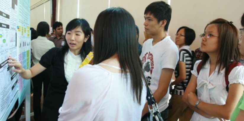 Members of the public listening to a student’s poster presentation