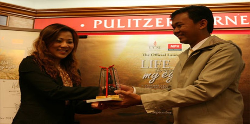  Muhamad Hafiz bin Ismail receiving a token of appreciation from Ms Ivy Tan, General Manager of MPH Publishing Group