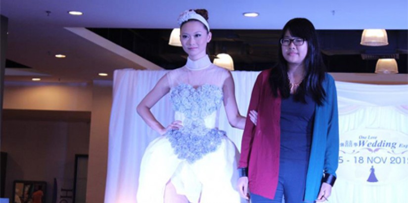  WINNING DESIGN (From right) Fashion student Kang Chee Vie posing with a model dressed in her “Victorian tea time in the garden”-inspired design that won her the grand prize at KSL’s bridal competition cum exhibition.