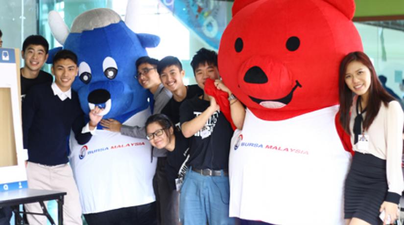 Chai (second from left) and his fellow student organisers with the Bursa Malaysia mascots at the event.