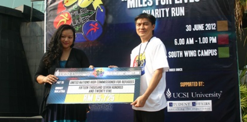 MAKING A DIFFERENCE:(From left)UCSI Group Vice President of Student Affairs and Alumini Mr Sylvester Lim presenting the mock cheque to Ms Yanti Ismail, spokesperson for UNHCR