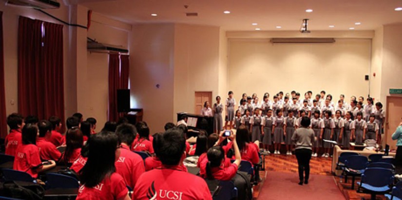 Students at Kian Kok Middle School sing to members of the UCSI University Chamber Choir during the choir's cultural exchange trip to Sabah.