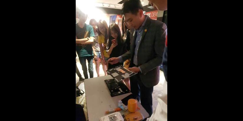 Choong disassembling a DELL laptop showing students the internal components.