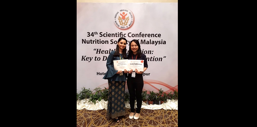Dr Satvinder and Ng Choon Ming with an award won at a scientific nutrition conference