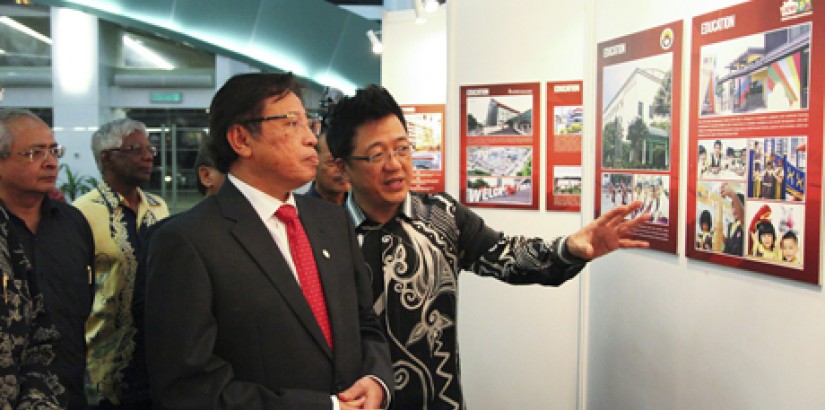 KEY MILESTONES: UCSI Group founder and chairman YBhg Dato’ Peter Ng explaining an exhibit comprising posters of UCSI’s significant milestones to Minister of Housing and Tourism (Sarawak) YBhg Datuk Amar Abang Johari Tun Openg during the recent UCSI Hotel 