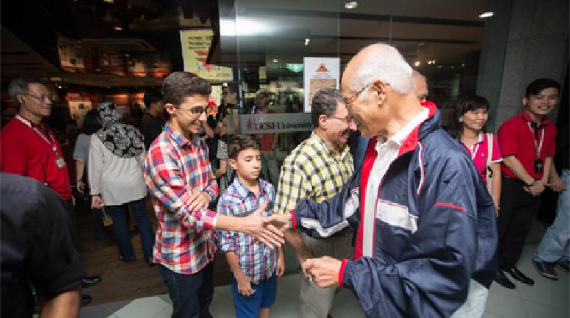 GENIAL: Tan Sri Arshad mingling with UCSI staff members and their children.
