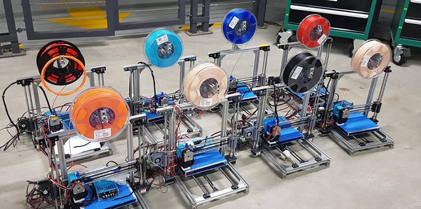 A collection of 3D printers at the end of the workshop.
