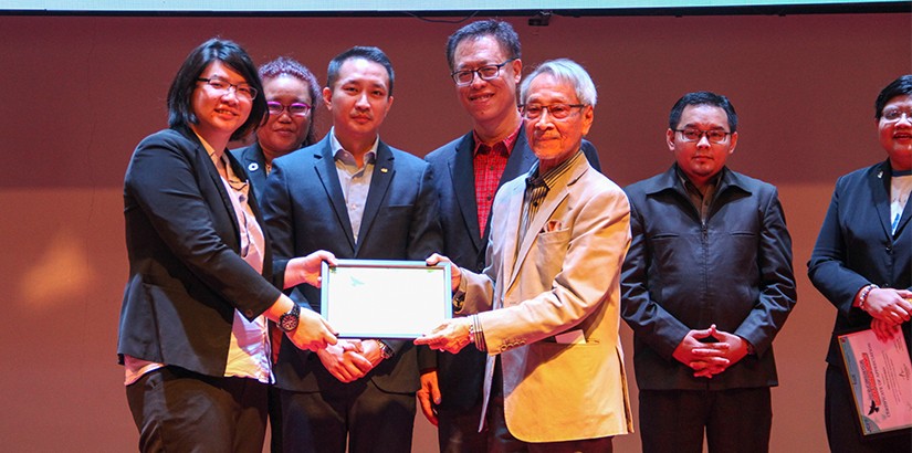 Academician Professor Emeritus Tan Sri Dr Omar Abdul Rahman receiving a token of appreciation from the organising chairperson, Joyline Chai. 