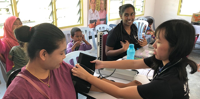 UCSI MedicSA volunteers checking the blood pressure of a fellow villager.