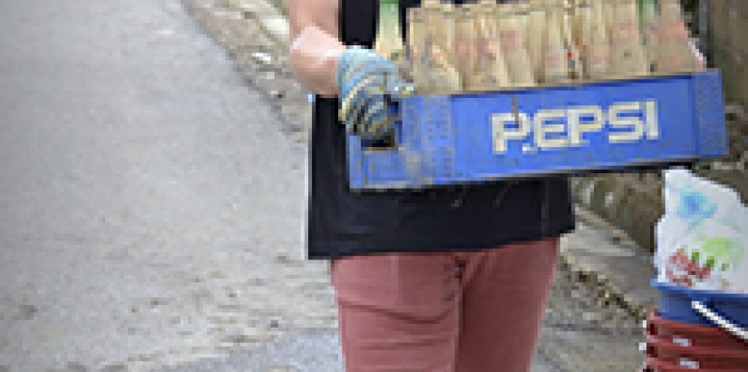  EMPTY BOTTLES: An engineering student from UCSI clearing away mud-caked bottles.