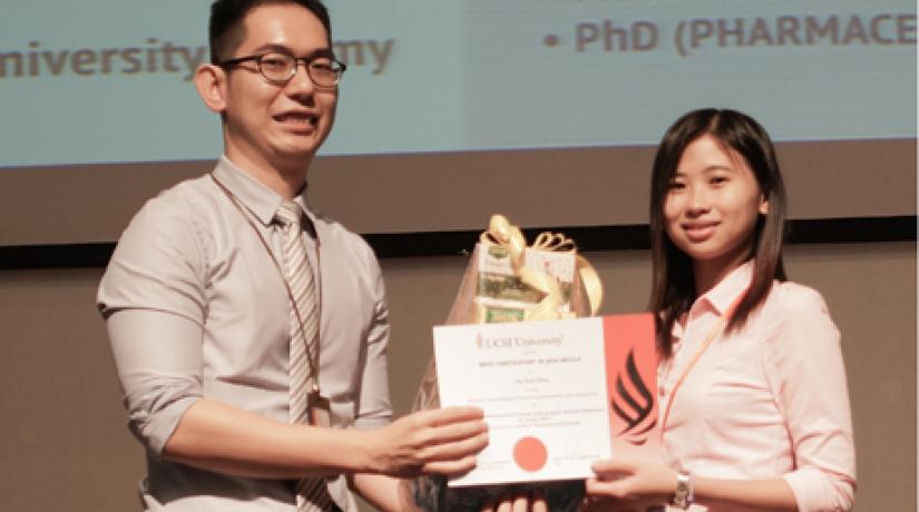 Young Researcher: Organising Chairman Asst Prof Dr Lee Ming Tatt presenting the prize to Low Huey Thing, the winner of the Best Participant in Q&A Skills award.