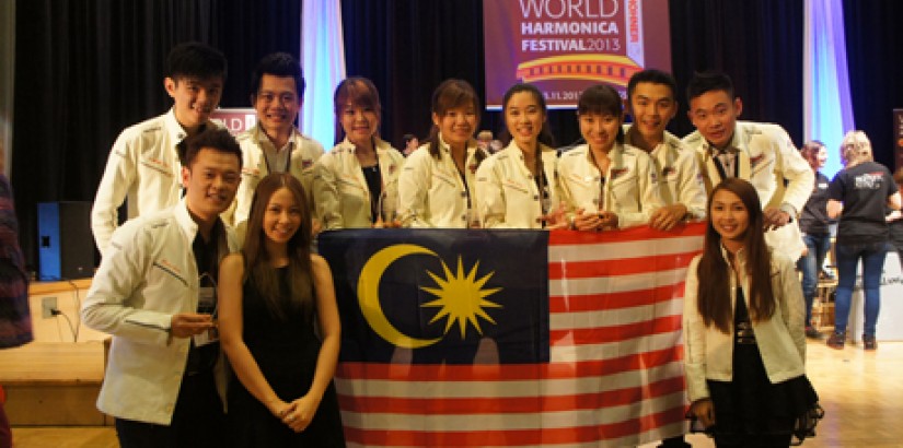  ALL SMILES: Fresco Harmonica – including its founders and UCSI alumni Evelyn Choong (first row, most right) and Aiden Soon (first row, most left) – posing for a group shot at the World Harmonica Festival in Trossingen, Germany after netting multiple wins