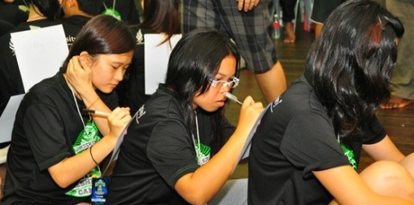 Campers writing down their thoughts about one another during one of the workshops.