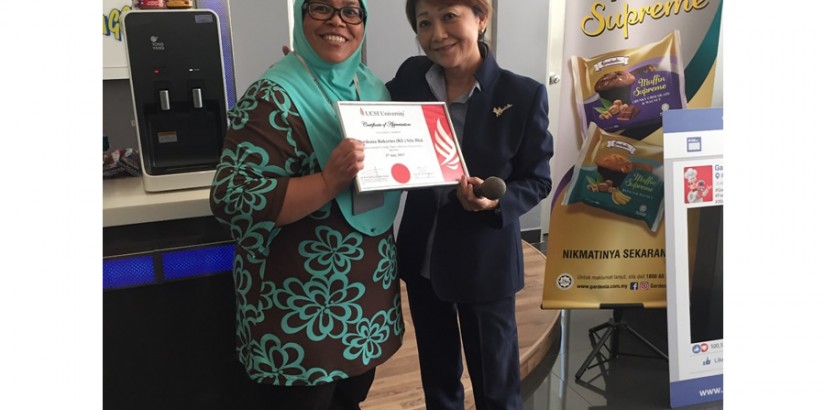 Presentation of token of appreciation by Ms. Noorsiah to Ms. Aishah