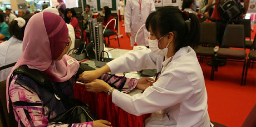 A student from UCSI University's Pharmacy Student Association (UCSIUPSA) from the Faculty of Pharmaceutical Sciences attending to a patient during the 10th Annual Public Health Campaign 2011 held in Kuantan