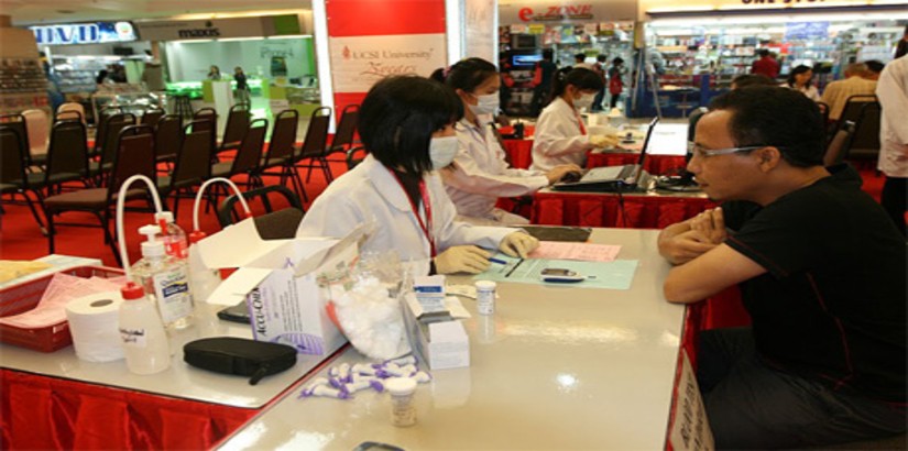 A student from UCSI University's Pharmacy Student Association (UCSIUPSA) from the Faculty of Pharmaceutical Sciences attending to a patient during the 10th Annual Public Health Campaign 2011 held in Kuantan