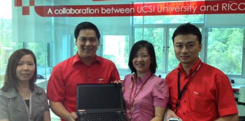  Hilti representatives presenting the laptop and Samsung Galaxy S3 smartphone as their initial token of collaboration between them and UCSI University School of IT, represented here by Ms Chloe Thong, Head of the School of IT.