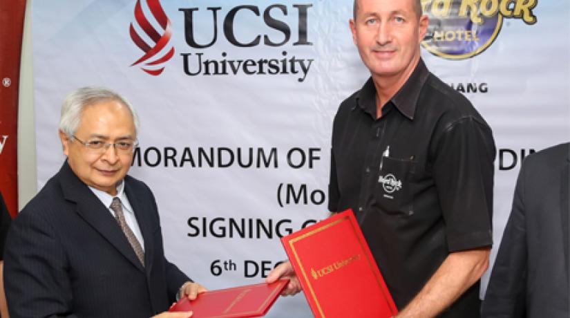 Senior Professor Dato' Dr Khalid Yusoff (left), Vice-Chancellor and President of UCSI University and John Primmer (right), General Manager of Hard Rock Hotel Penang exchanging the signed agreements.