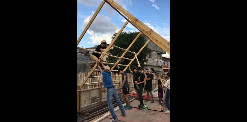 Students go the extra mile to build the hut for the locals.