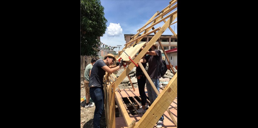 Students hard at work building the hut.