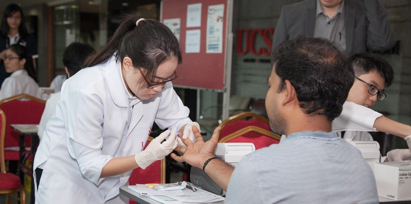 UCSI student doing her part in serving the community.