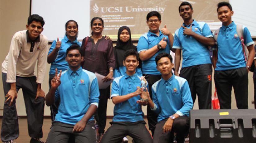 The team from SMK Bandar Damai Perdana, who won the 1st Runner Up prize, shares a light moment with their English teacher.