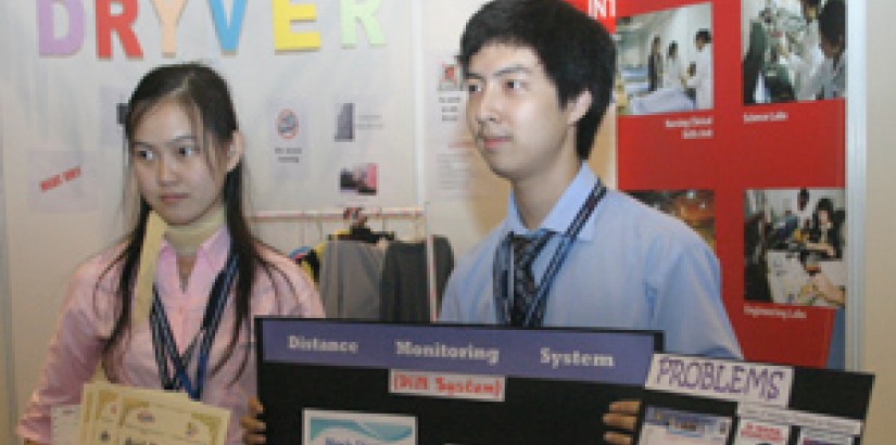 Mimi Iriana and Joshua Tan Wai Kiat posing with the Distance Monitoring System (DiM)