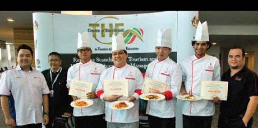 IRON CHEFS:Liew(centre) dispaly his winning dish together with judges and participants (from left) Lao, Dorge, Chin, Sim, Muneeb and Joseph