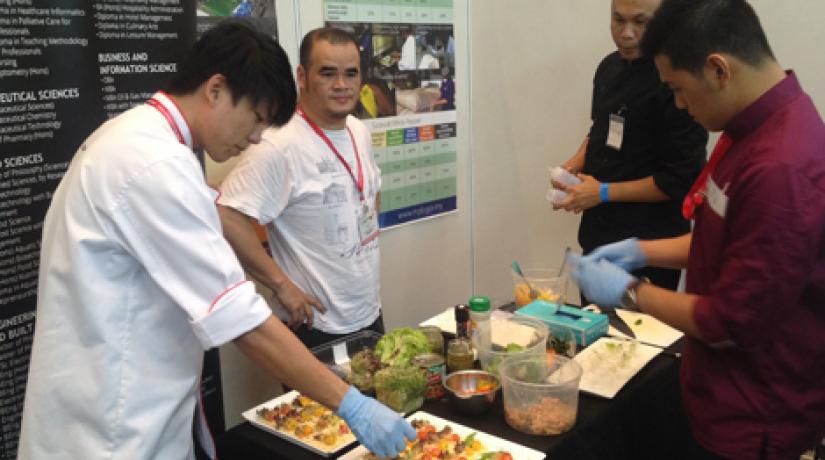 CHEFS AT WORK: Joseph Martin Pudun (lecturer), Tomy Wijaya and Edison Teo preparing the dishes.