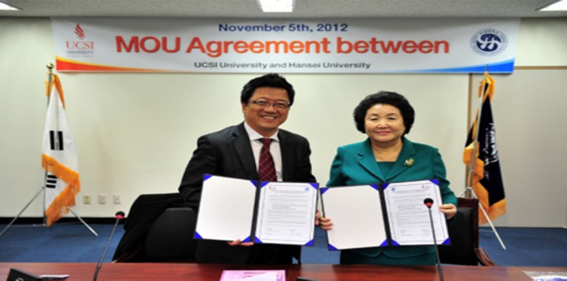 ALL SMILES: Dato' Peter Ng, UCSI Group's chairman and founder and Dr Kim Sunghae cho, president of Hansei University posing for the camera with their signed MoUs.