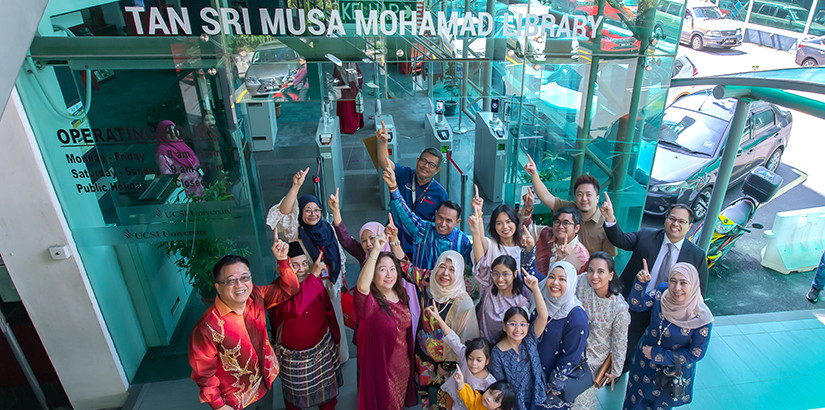 IN LOVING MEMORY: Puan Sri Fauziah Shahrom (fourth from left) and UCSI University council chairman Dato’ Peter Ng (far left) pose with their families in front of the Tan Sri Musa Mohamad library.