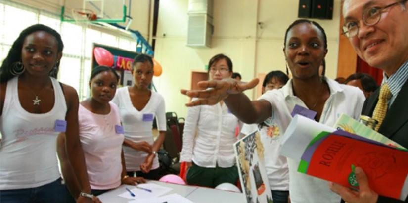 A student proudly shows UCSI University’s Vice Chancellor, Dr. Robert Bong her team’s community project
