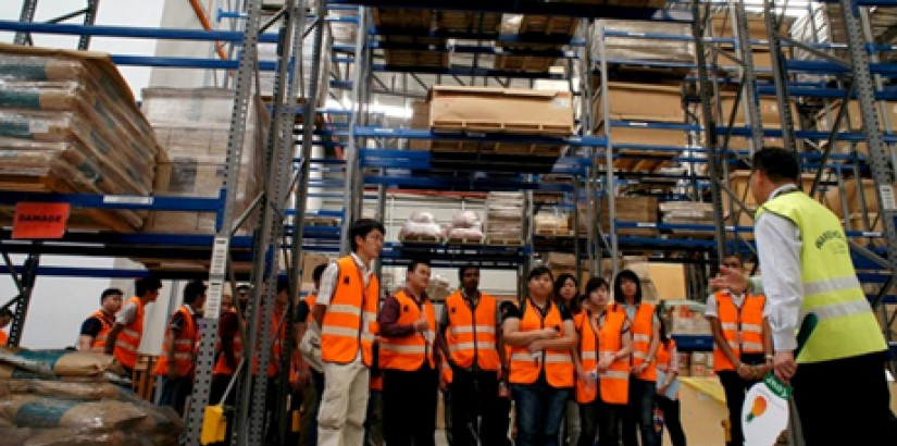 ALL EARS: Student at a briefing during a warehouse tour at PKT Logistics