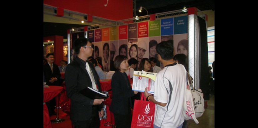 Course counselors advising visitors on course offerings at UCSI University.