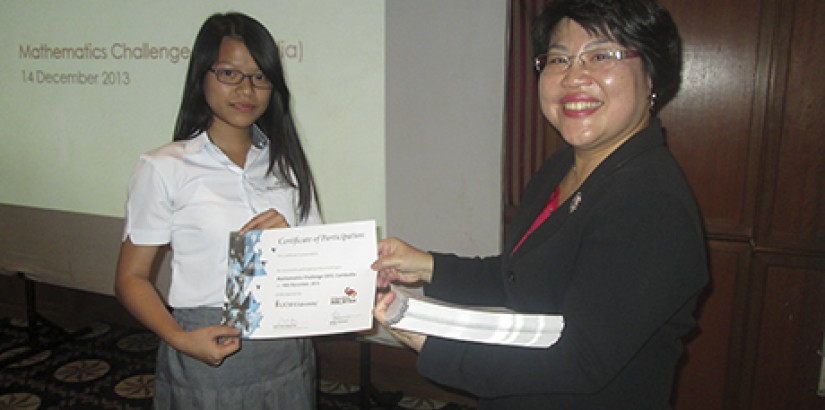 WELL DONE (From right): UCSI Centre for Pre-U Studies Director Assistant Professor Mabel Tan presenting a certificate of participation to a student during the Maths Challenge in Cambodia