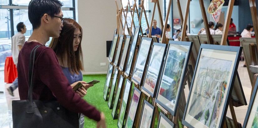 Visitors looking at the artworks from participants of mySENI 2019 Painting Competition.