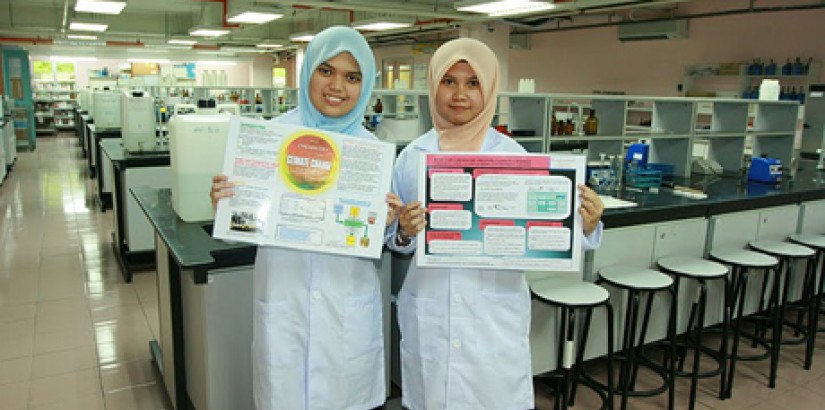 UCSI University A-Level Academy students Siti Nur Aelina Abu Bakar (left) and Hafizah Razy hold up their winning posters after being selected to win a free trip to England to attend the University of Bath International Science Summer School.