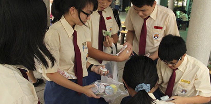  CARING STUDENTS: Students selling candies and badges to raise funds.