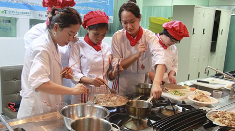  TEAMWORK: Students working together to cook bulgogi.