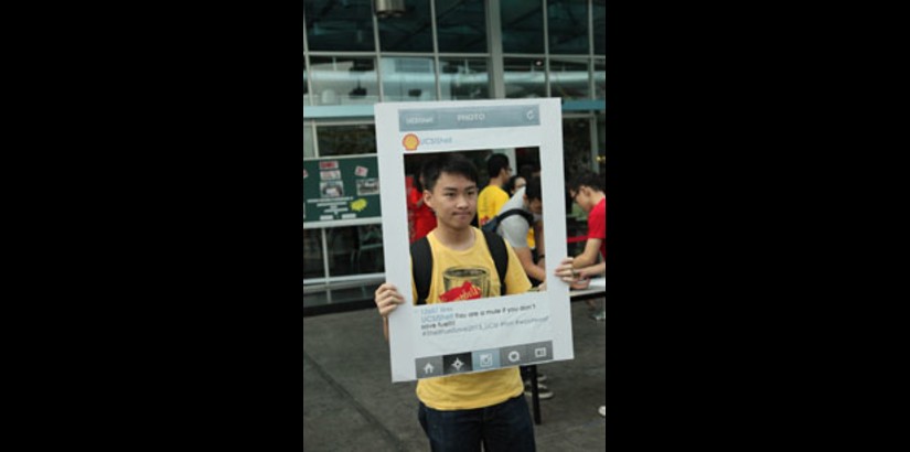 A UCSI student participating in the creative photo contest on campus grounds during the Shell FuelSave College Competition 2013.