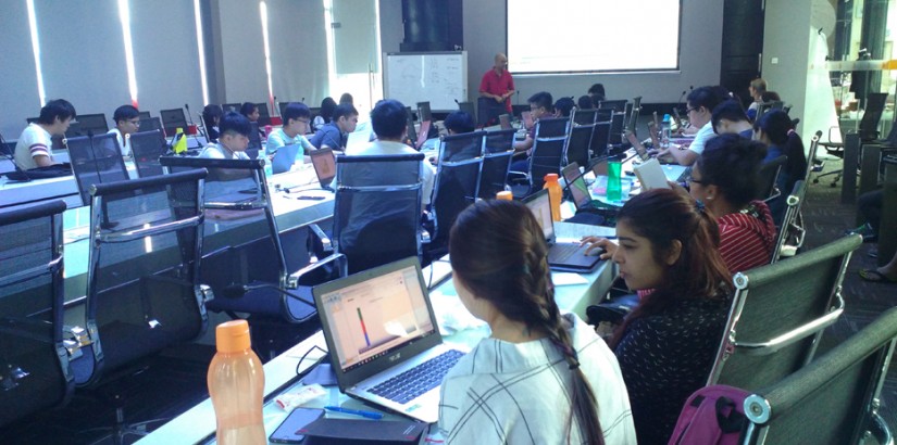 Students paying close attention to Dr Dazmin as he explains the various functions of the SPSS software.